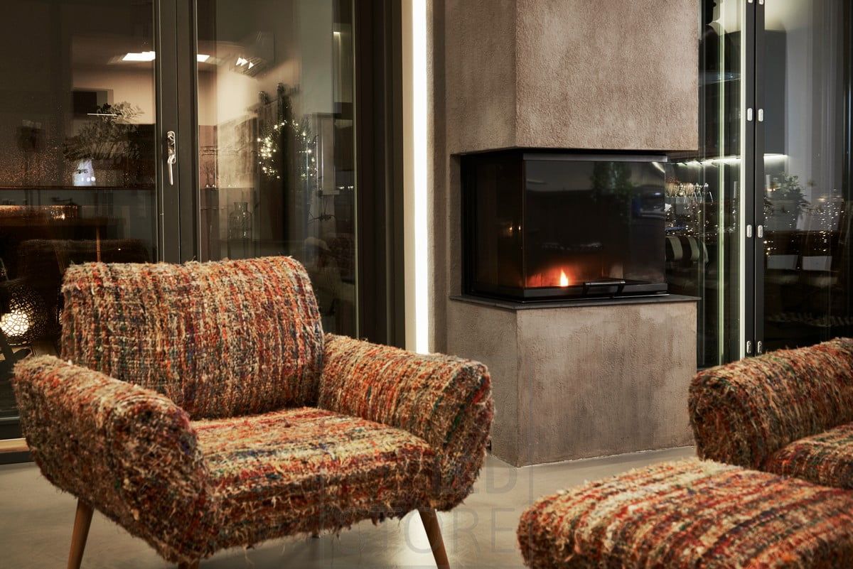 LED strip mounted behind the fireplace, indirectly illuminating through the wall, creating mood lighting and highlighting the fireplace. Ledstore.fi